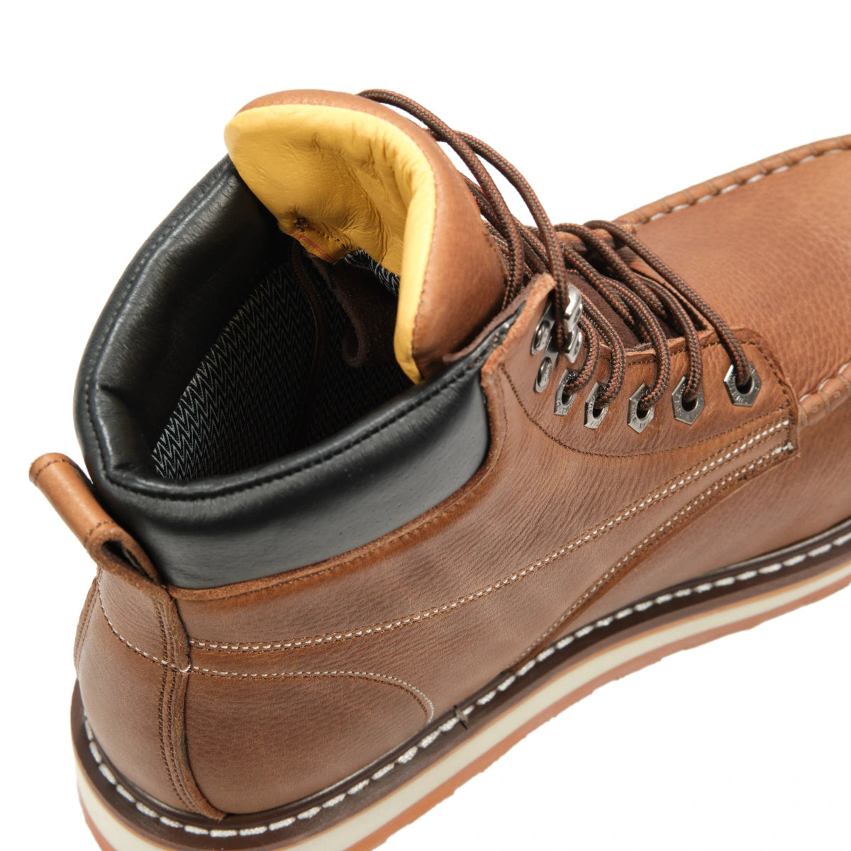 SUREWAY 601M tobacco brown leather work boot close-up, showing the padded black collar, yellow tongue lining, metal lace hooks, and contrast stitching.